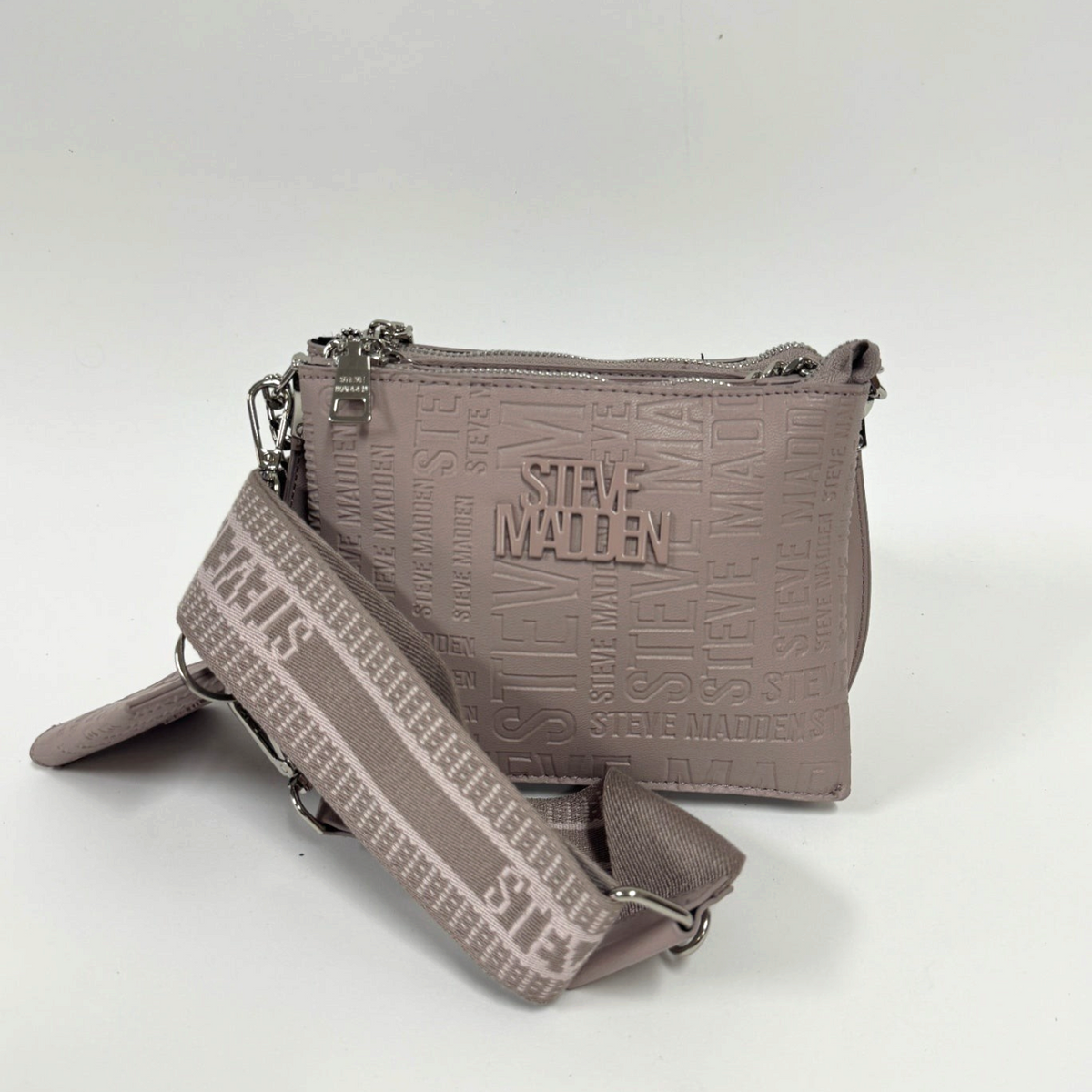 Lynn's Closet Boutique taupe Steve Madden Bvice crossbody bag with embossed logo pattern and branded webbing strap