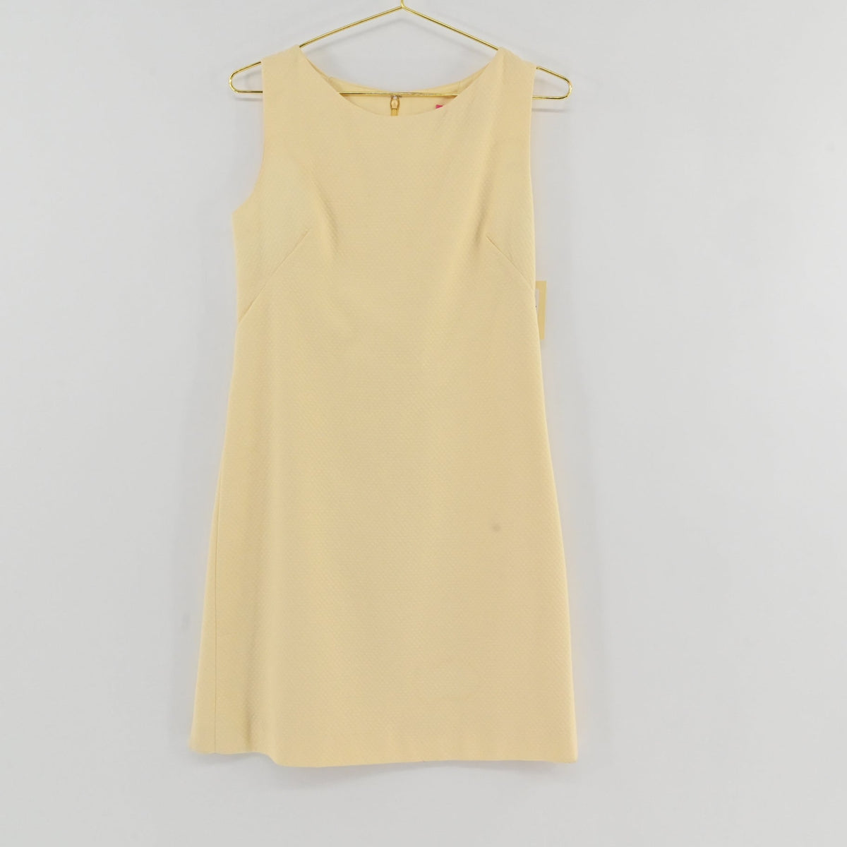 Lynn's Closet Boutique Steven Stolman butter yellow sleeveless shift dress with a boat neckline and textured fabric.