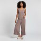 Model wearing a Lynn's Closet Boutique tan pleated sleeveless top and wide-leg trousers set with white sandals.