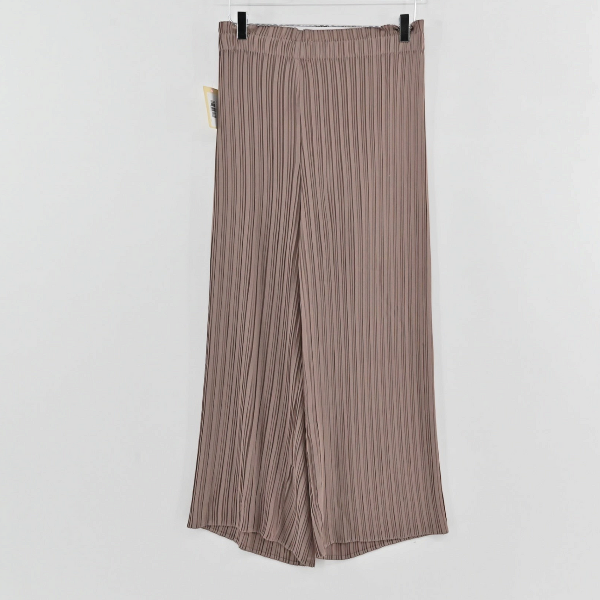 Lynn's Closet Boutique tan pleated wide-leg trousers with an elasticized waistband hanging on a clear hanger.