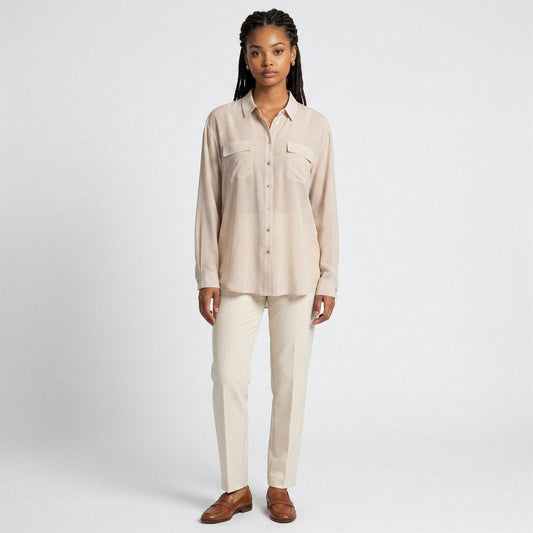 Model wearing Lynn's Closet Boutique tan silk-blend button-down shirt with chest pockets and cream trousers
