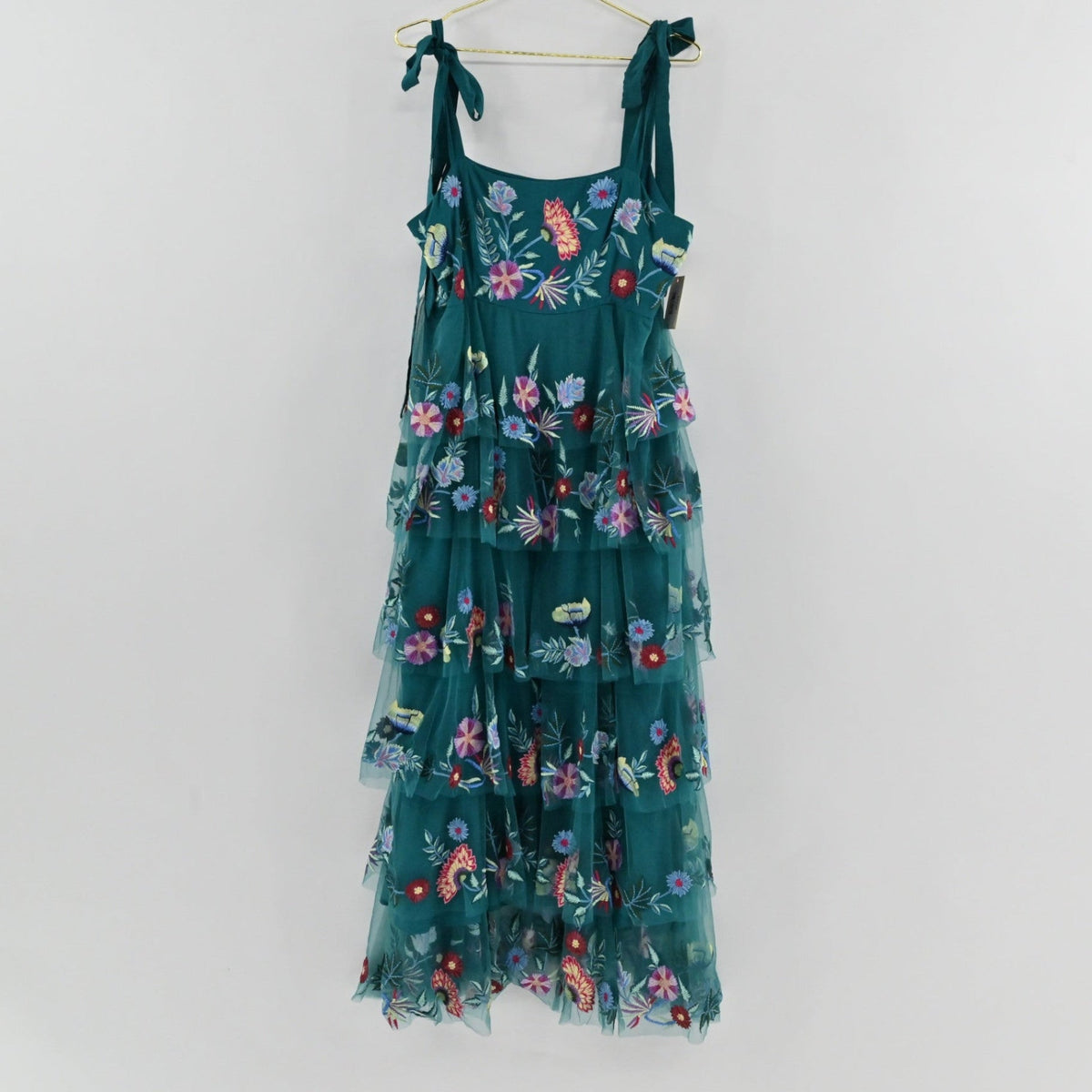 Lynn's Closet Boutique teal floral maxi dress with tiered tulle skirt, tie-shoulder straps, and colorful embroidery.