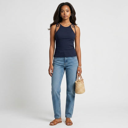 Model wearing Lynn's Closet Boutique Theory Hartmann navy ribbed sleeveless top with tie-shoulder straps and blue jeans