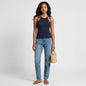 Model wearing Lynn's Closet Boutique Theory Hartmann navy ribbed sleeveless top with tie-shoulder straps and blue jeans