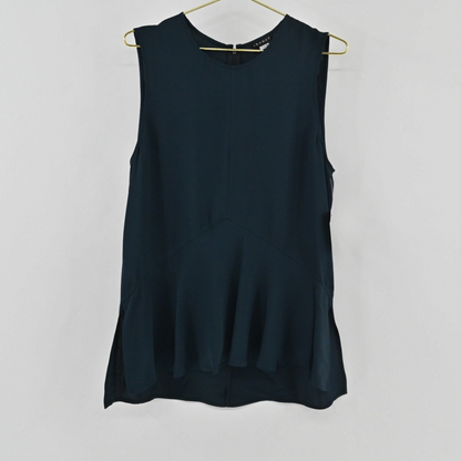 Lynn's Closet Boutique navy blue Theory sleeveless silk top with a peplum waist detail hanging on a gold hanger.