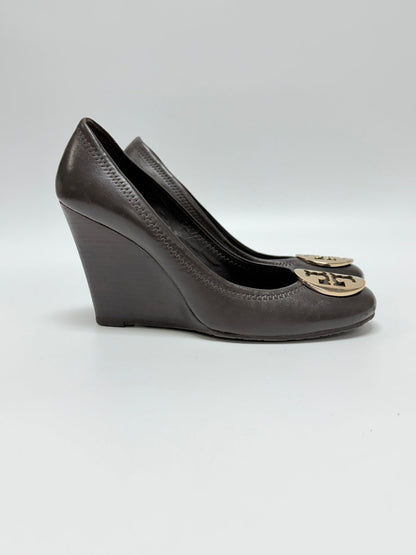 Lynn's Closet Boutique brown leather Tory Burch wedge shoes with gold logo medallion on a white background.