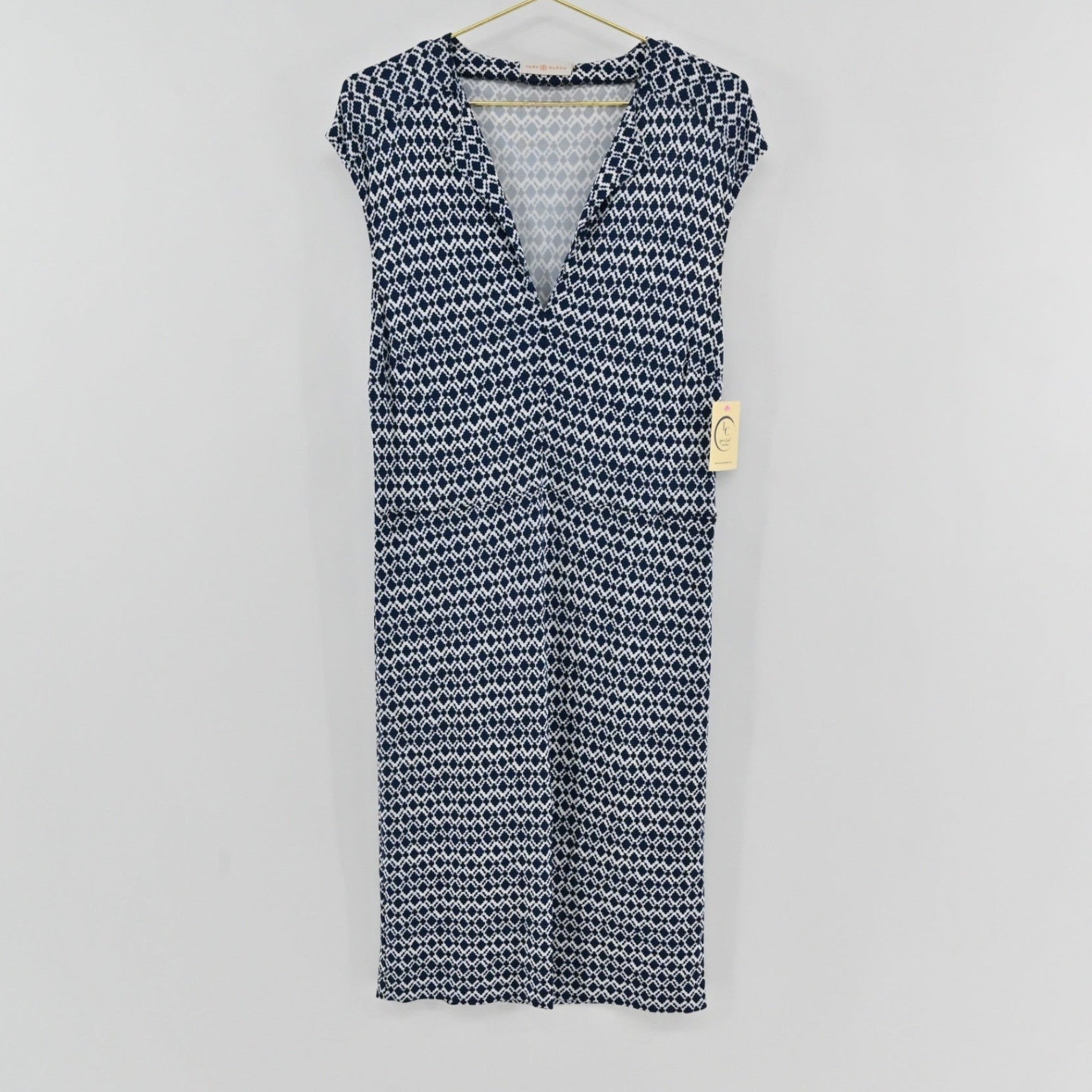 Lynn's Closet Boutique Tory Burch navy and white diamond print V-neck dress with cap sleeves hanging on a hanger.