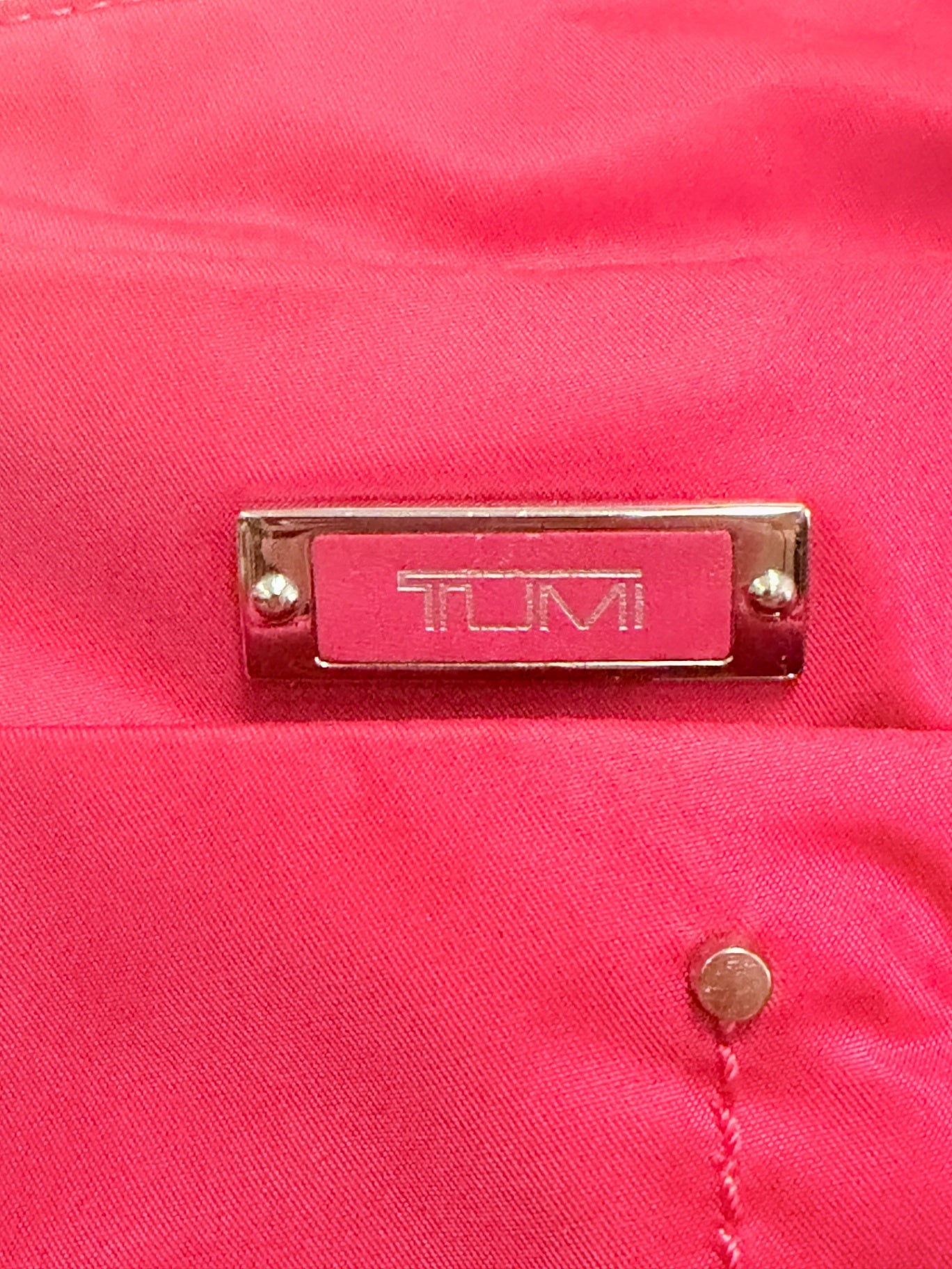 Lynn's Closet Boutique Tumi Voyageur hot pink nylon crossbody bag featuring a silver metal logo plaque detail.