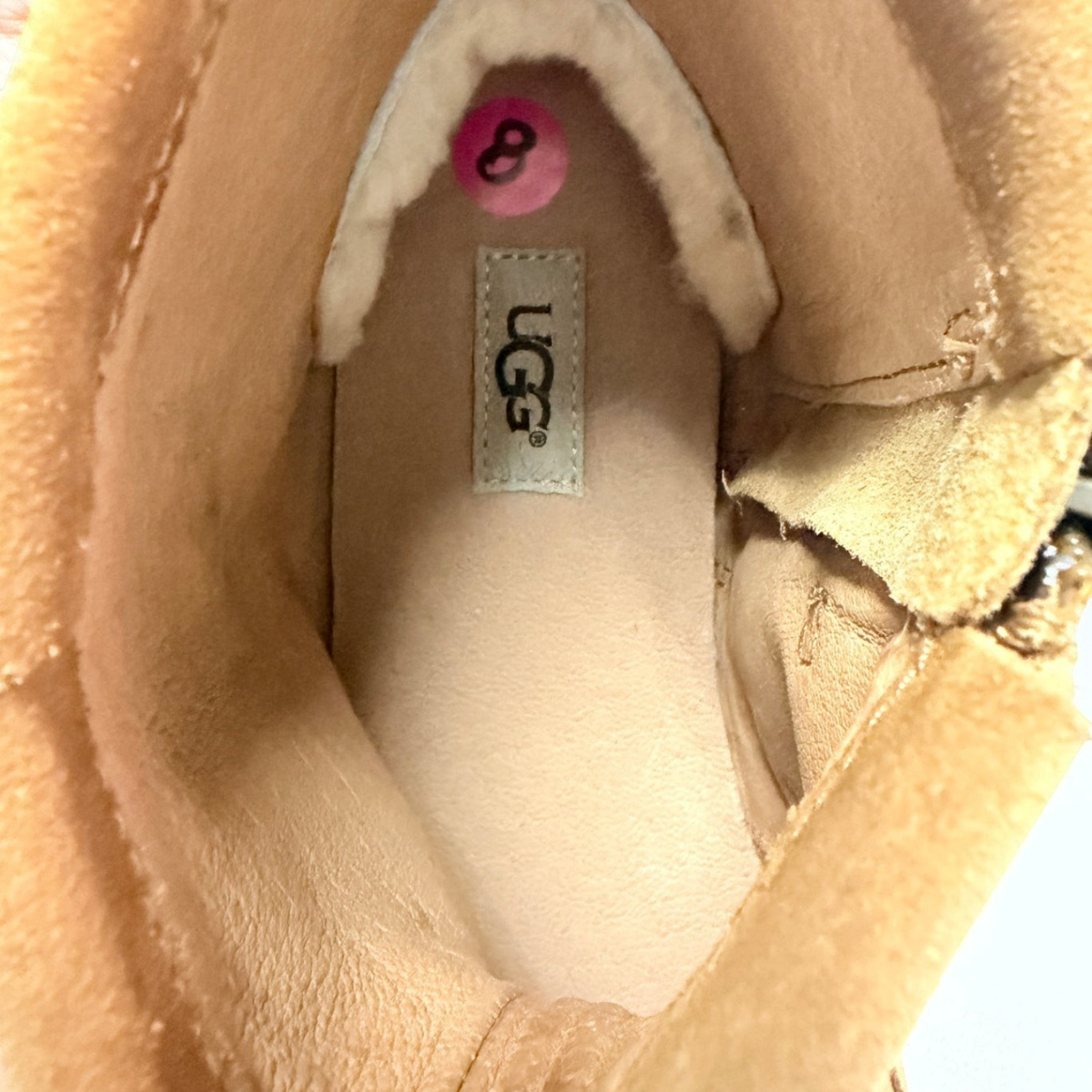 Interior view of Lynn's Closet Boutique UGG brown suede moccasin boot showing size 8 label and plush lining