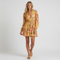 Model wearing a Lynn's Closet Boutique Ulla Johnson yellow and coral floral wrap mini dress with tiered ruffle skirt.