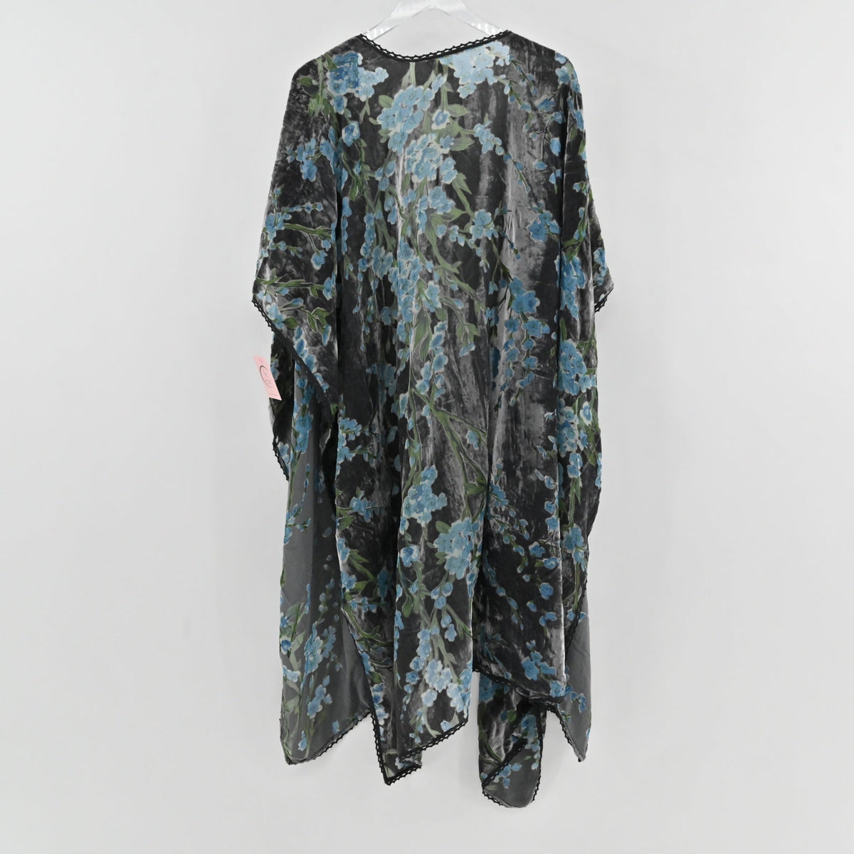 Lynn's Closet Boutique velvet burnout floral shawl in black with blue flowers and scalloped lace trim, hanging view.