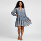 Model wearing a Lynn's Closet Boutique Veronica Beard blue chambray dress with white eyelet embroidery and tiered hem