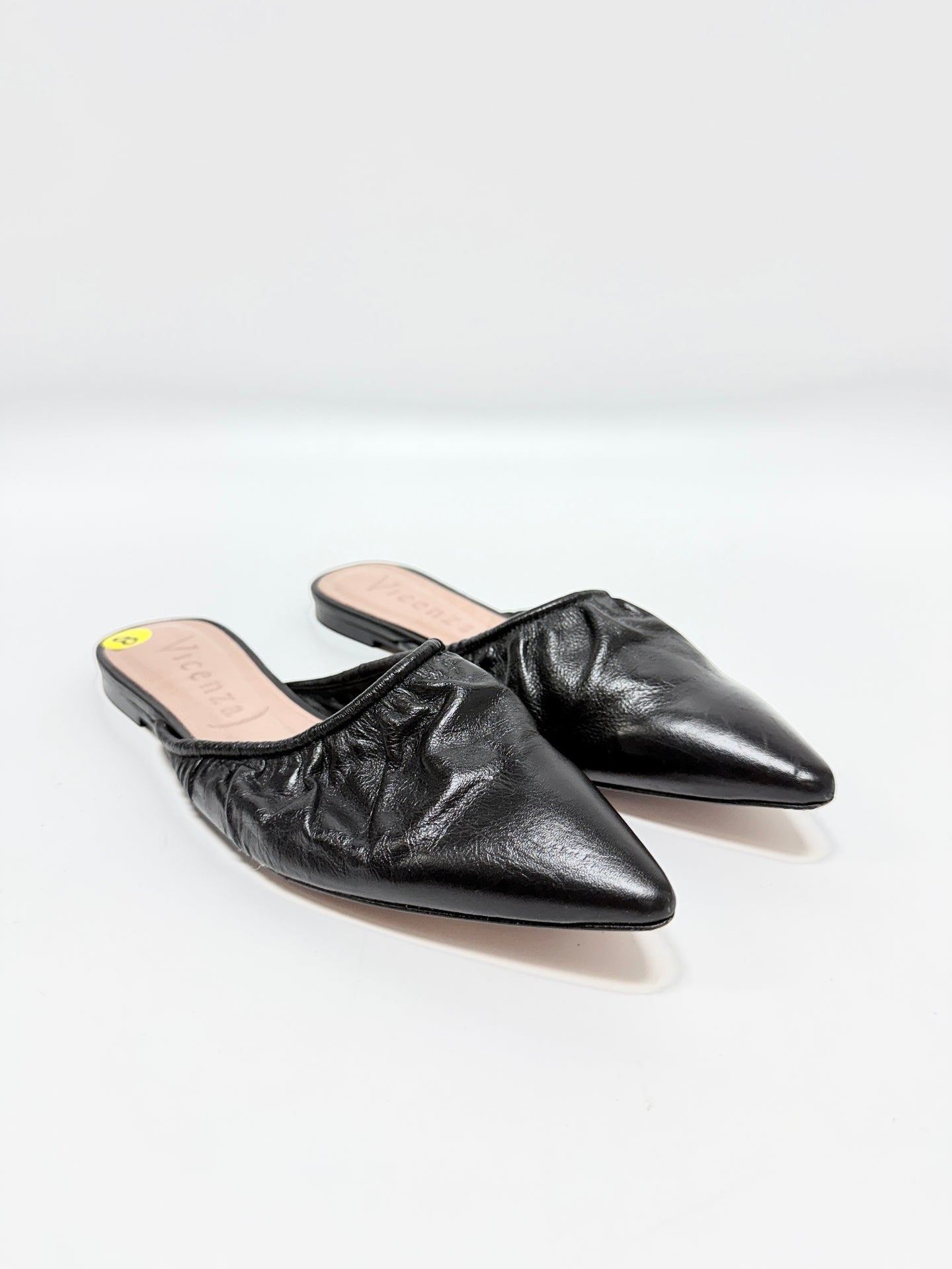 Lynn's Closet Boutique Vicenza black leather mules with ruched texture and pointed toe, size 8 slip-on flats.