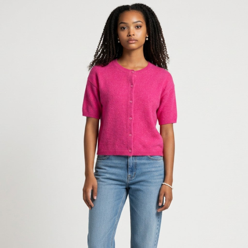 Model wearing a Lynn's Closet Boutique Vince Camuto bright pink short sleeve button-up cardigan with blue jeans.