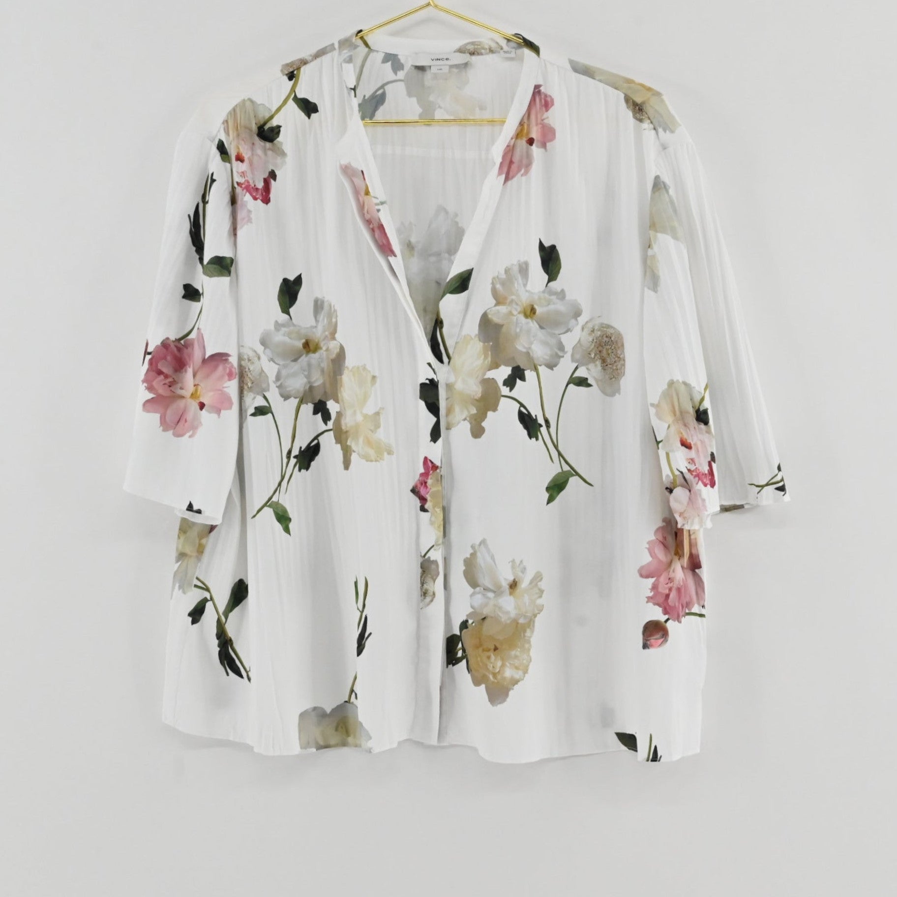 Lynn's Closet Boutique Vince floral V-neck top in white with pink and green botanical print and pleated texture.