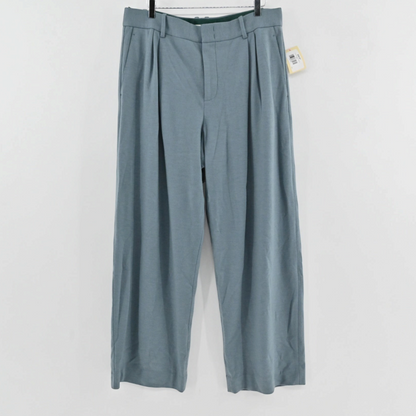 Lynn's Closet Boutique Vince blue-grey wide-leg trousers with front pleats and belt loops hanging against a white wall.