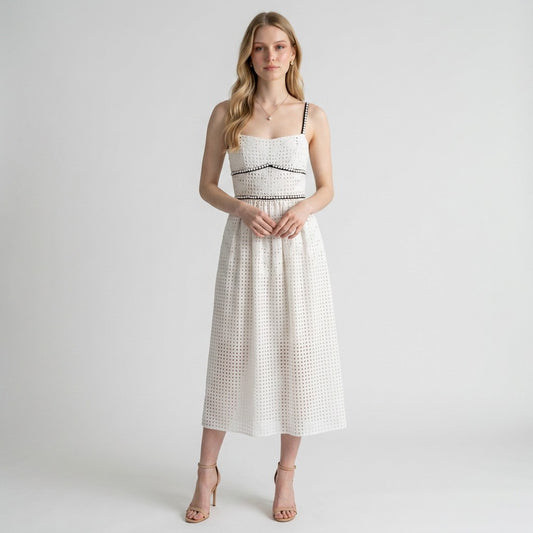Lynn's Closet Boutique white eyelet midi dress with black trim and spaghetti straps worn by a blonde model