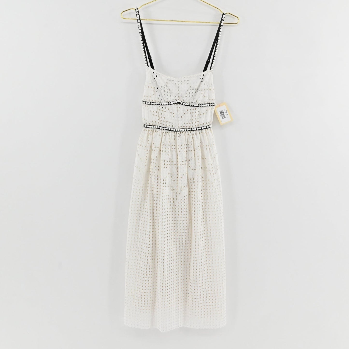 Lynn's Closet Boutique white midi eyelet dress with black trim and faux pearl accents on straps and waist