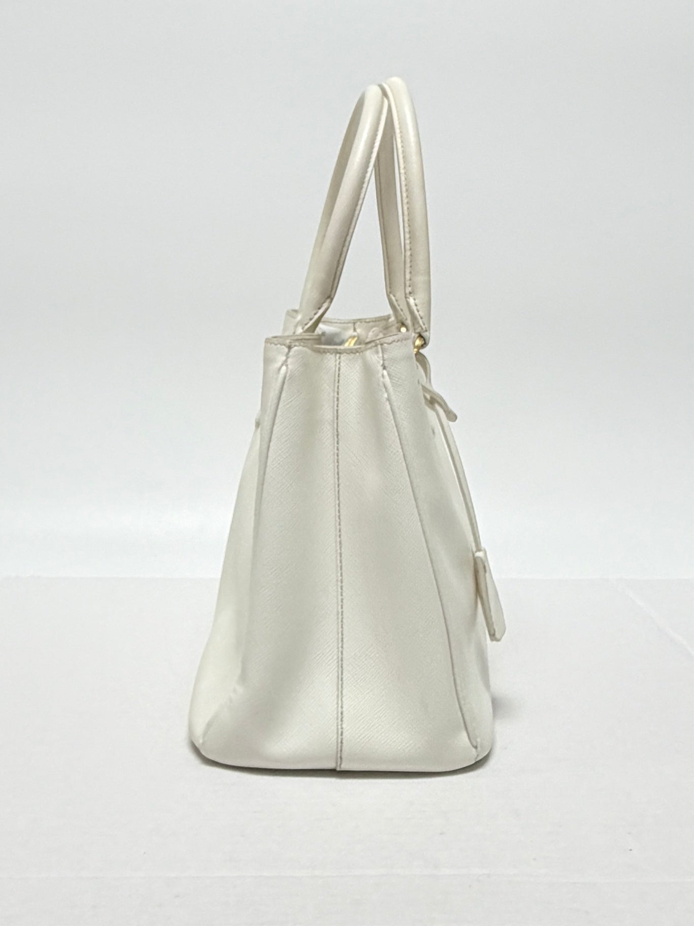 Lynn's Closet Boutique white Prada Galleria Saffiano leather medium handbag, side view showing structured silhouette.