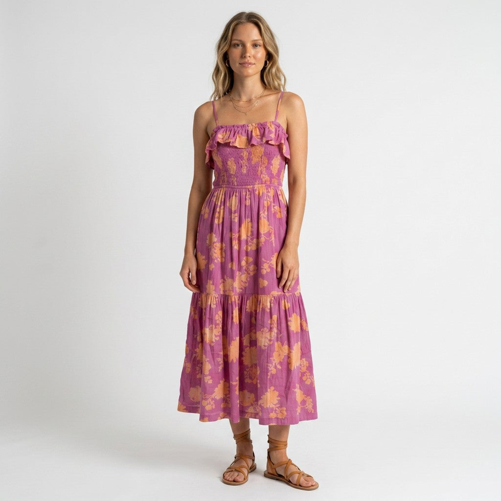 Model wearing a Lynn's Closet Boutique Z Supply purple and orange floral midi dress with a smocked bodice and ruffles.