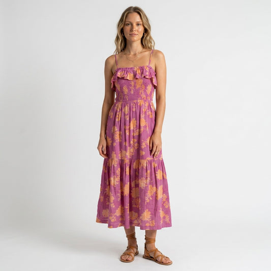 Model wearing a Lynn's Closet Boutique Z Supply purple and orange floral midi dress with a smocked bodice and ruffles.