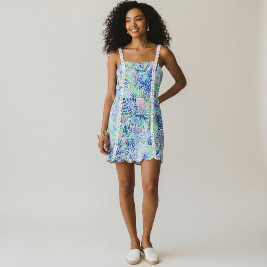 Lynn's Closet Boutique Lilly Pulitzer Jesse Romper in size 12, featuring a vibrant floral print in blue, green, and pink with white lace trim and scalloped hem.