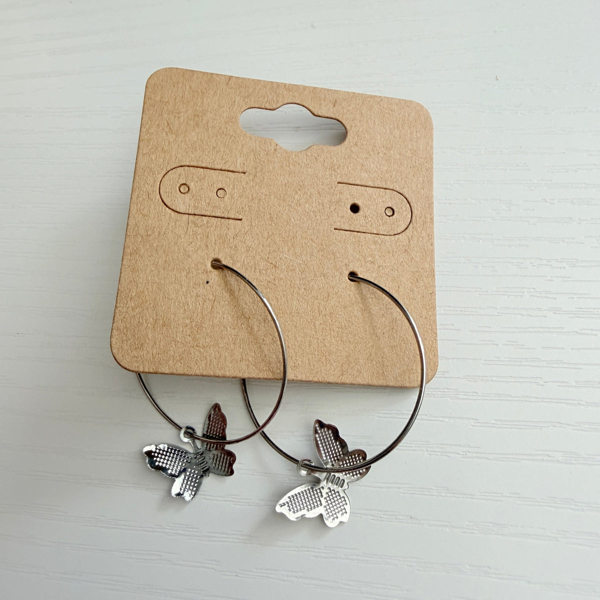 Silver butterfly charm hoop earrings
