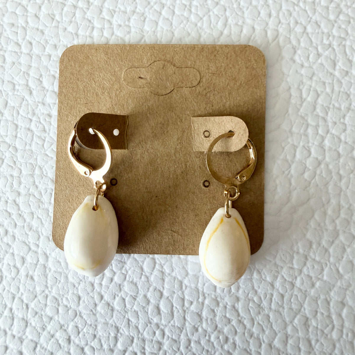 Gold cowrie shell drop huggie earrings